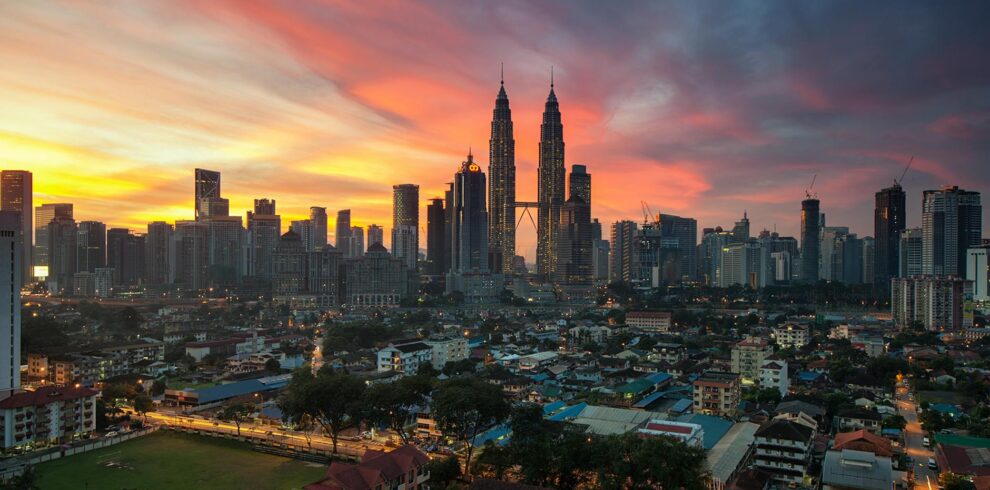 city buildings under orange sunset